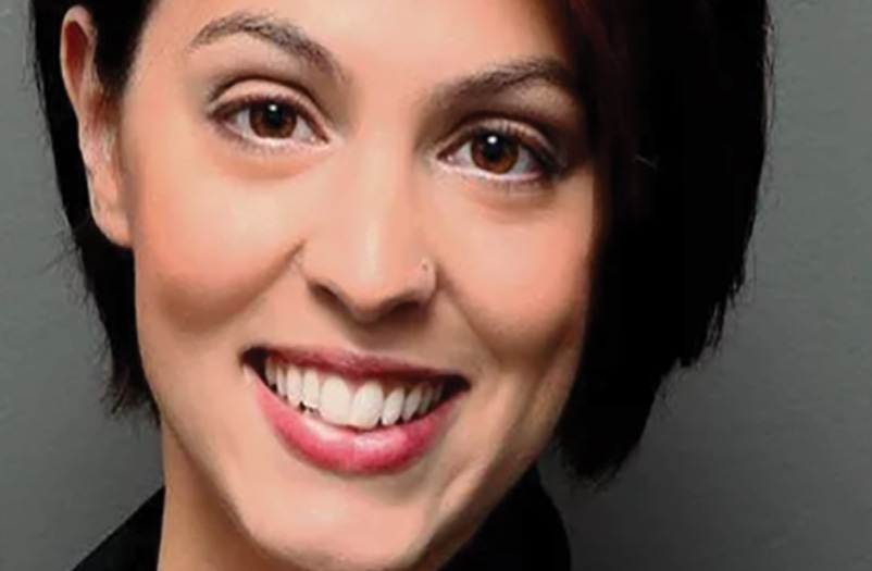 A closeup portrait of a young woman with short dark hair.